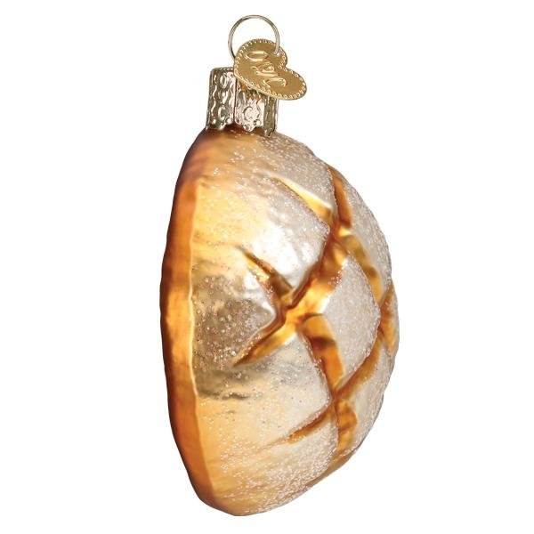 Sourdough bread ornament side view, golden crust curving around the scored top
