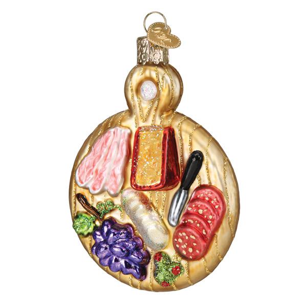 Charcuterie board ornament with cured meat, red-rind cheese, salami, grapes, olives, and a knife, front view