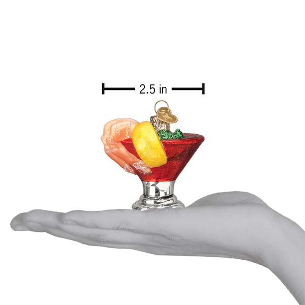 Shrimp cocktail ornament on an open palm under a 2.5 inch width marker for scale
