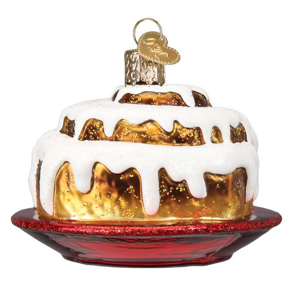 Back of the cinnamon roll ornament, white icing running down the golden roll