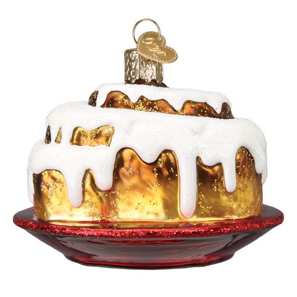 Cinnamon roll ornament at an angle showing the icing on top and the glossy red plate