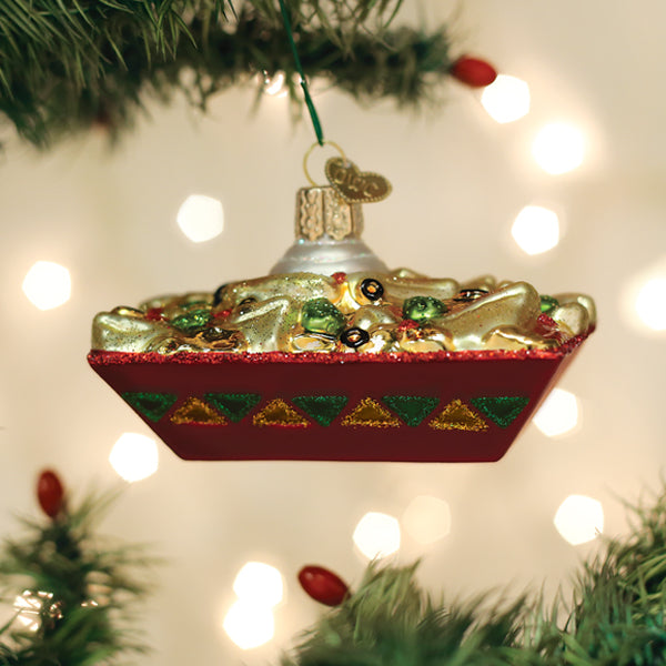 Nachos glass ornament hanging on a Christmas tree with red lights and soft bokeh for game day fans
