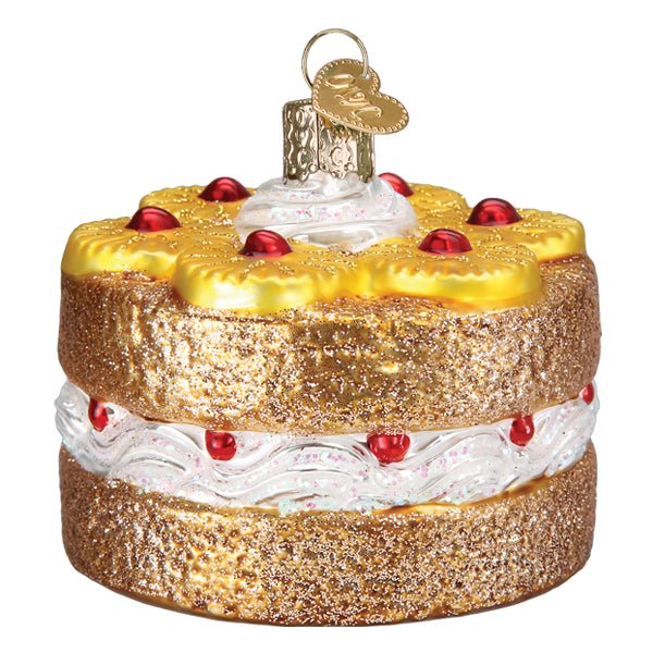 Pineapple upside down cake ornament turned slightly, glittered golden layers and white cream filling