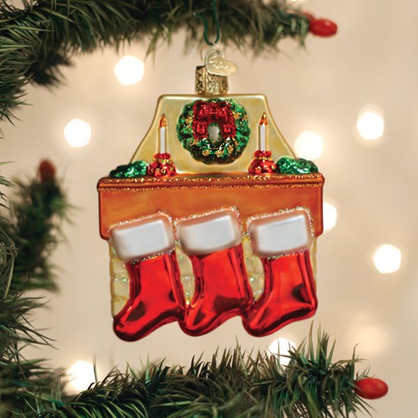 Family of 3 stockings ornament hanging on a lit Christmas tree with warm bokeh lights