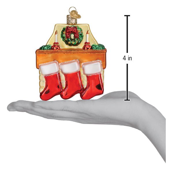 Family of 3 stockings ornament on an open palm beside a 4 inch height marker