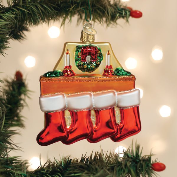 Family of 4 stockings ornament hanging on a lit Christmas tree with warm bokeh lights