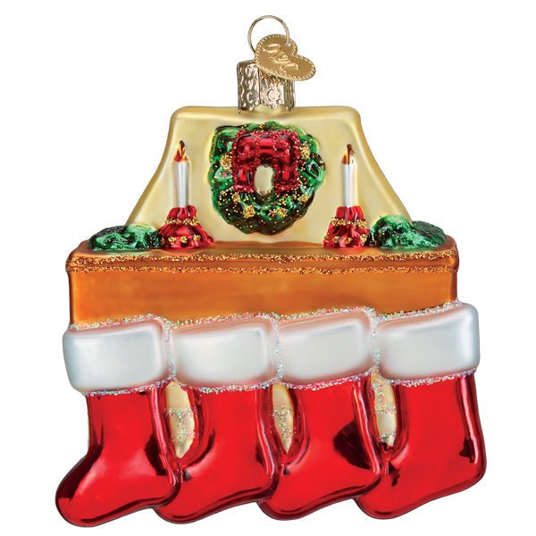 Front of the family of 4 stockings ornament with four red stockings on a mantel under a green wreath, on white