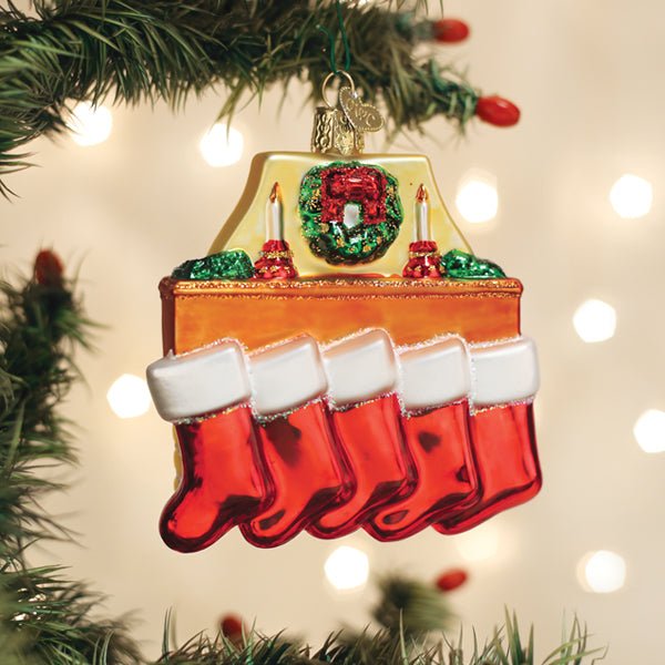 Family of 5 stockings ornament hanging on a lit Christmas tree with warm bokeh lights