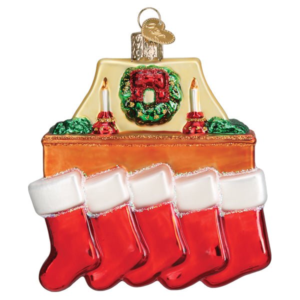 Front of the family of 5 stockings ornament with five red stockings on a mantel under a green wreath, on white