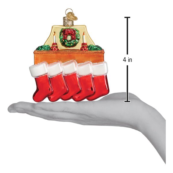 Family of 5 stockings ornament on an open palm beside a 4 inch height marker