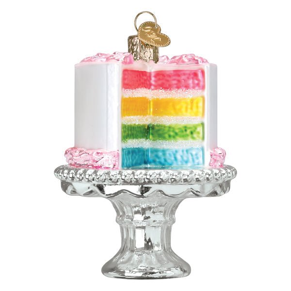 Rainbow cake on stand ornament front view, cut side showing pink, orange, yellow, green, and blue layers