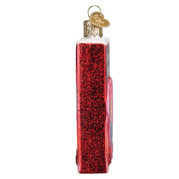 Side view of the conversation hearts ornament showing its red glittered edge and gold cap