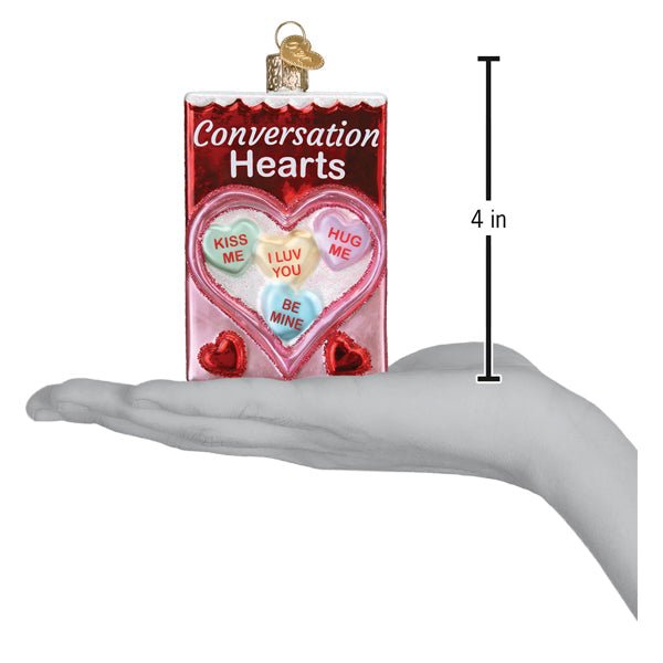 Conversation hearts ornament on an open palm with a 4 inch height marker