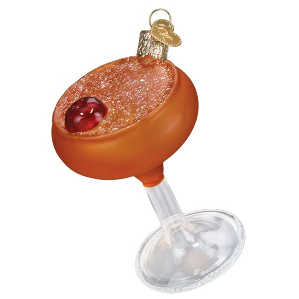 Manhattan cocktail ornament, amber drink in a coupe glass with two cherries, on white