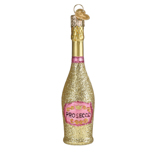 Gold and pink prosecco bottle ornament hanging on a lit Christmas tree