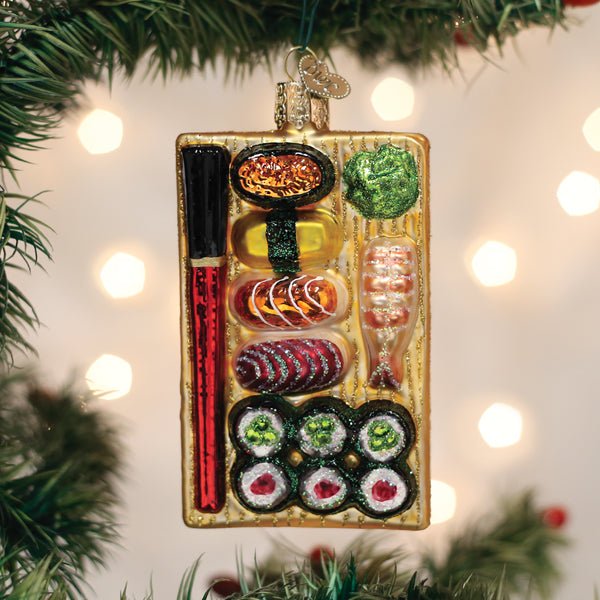 Sushi platter ornament hanging on a Christmas tree with soft glowing lights, a gift for sushi lovers