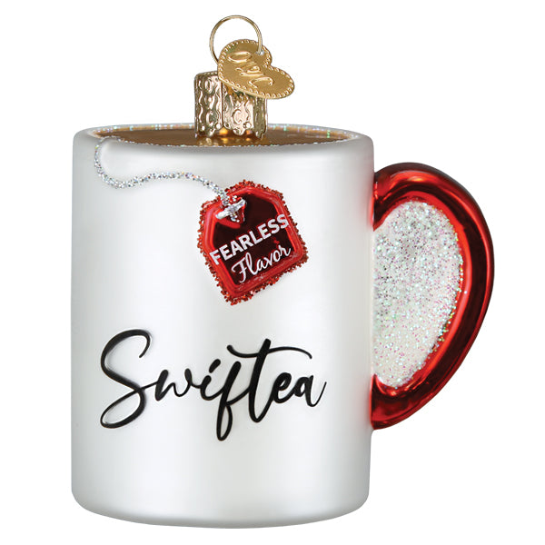 Front of the Swiftea mug ornament with black script lettering and a red Fearless Flavor tag, on white