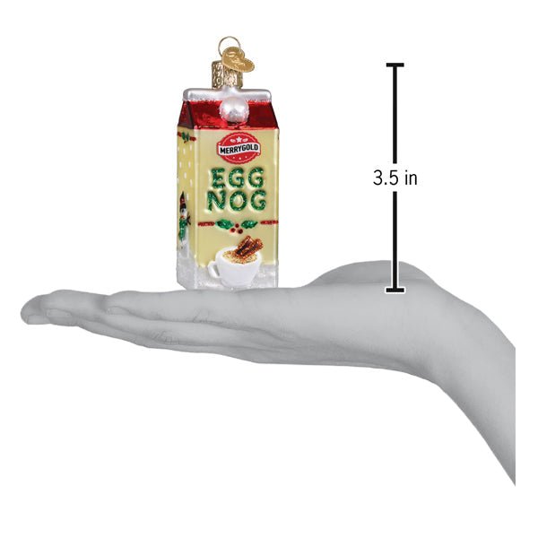 Eggnog carton ornament on an open palm beside a 3.5 inch height marker