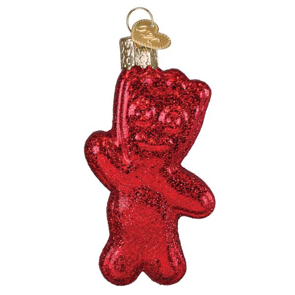 Red SOUR PATCH KID candy ornament, front view with a smiling face and waving arm in sparkly glitter, on white
