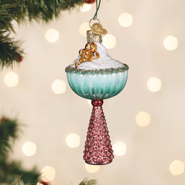 Gingerbread Glam cocktail glass ornament with sugared rim hanging on a lit Christmas tree