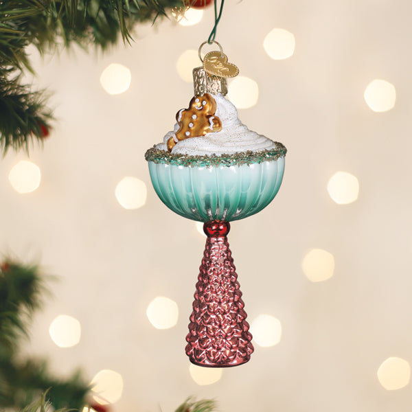 Gingerbread Glam cocktail glass ornament with sugared rim hanging on a lit Christmas tree