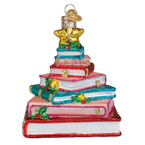 Front of the book club tree ornament, stacked red, pink, and teal books with a gold star, on white