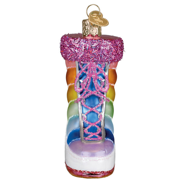 Front of the snow boot ornament with pink laces crisscrossing the rainbow bands