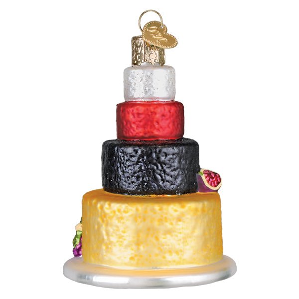 Side view of the cheese tower ornament showing the red and black wax wheels and a gold top