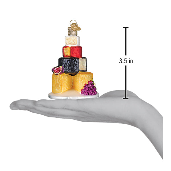 Cheese tower ornament on an open palm beside a 3.5 inch height marker