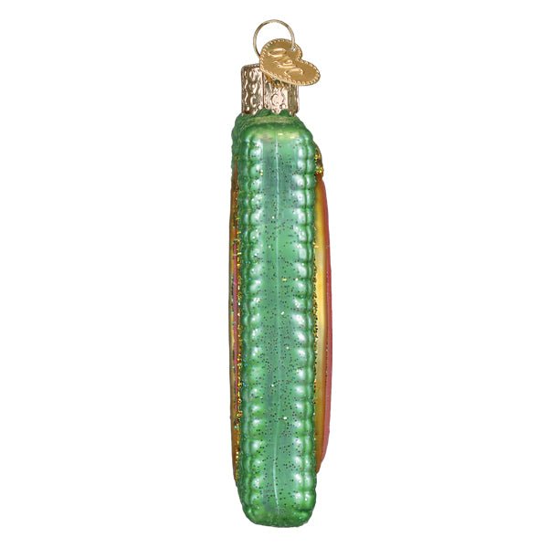 Slim side profile of the green cross stitch hoop ornament, on white