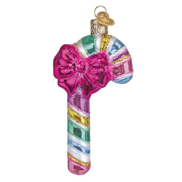 Pastel striped candy cane glass ornament with fuchsia bow and gold cap, front view on white