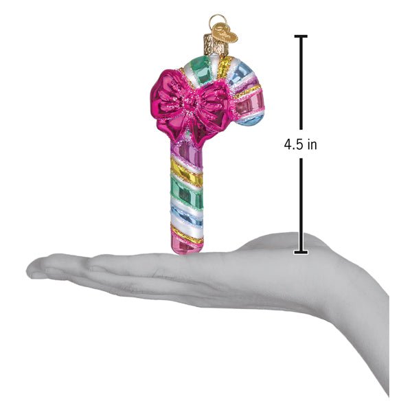 Pastel candy cane ornament resting on an open palm with a 4.5 inch height marker