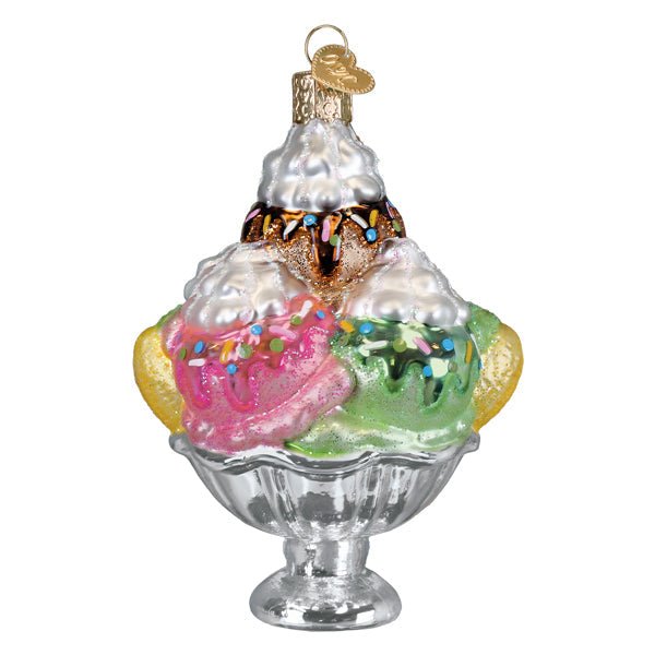 Angled side view of the sundae ornament showing sprinkles, whipped cream peaks, and the silver footed dish, on white