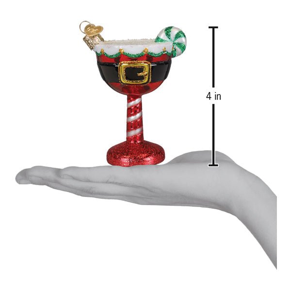 Santa cocktail ornament on an open palm beside a 4 inch height marker