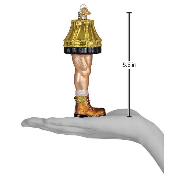 Man leg lamp ornament on an open palm beside a 5.5 inch height marker