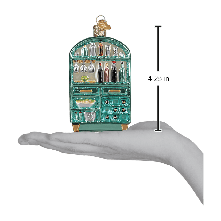 Cocktail bar cabinet ornament resting on an open palm beside a 4.25 inch height marker