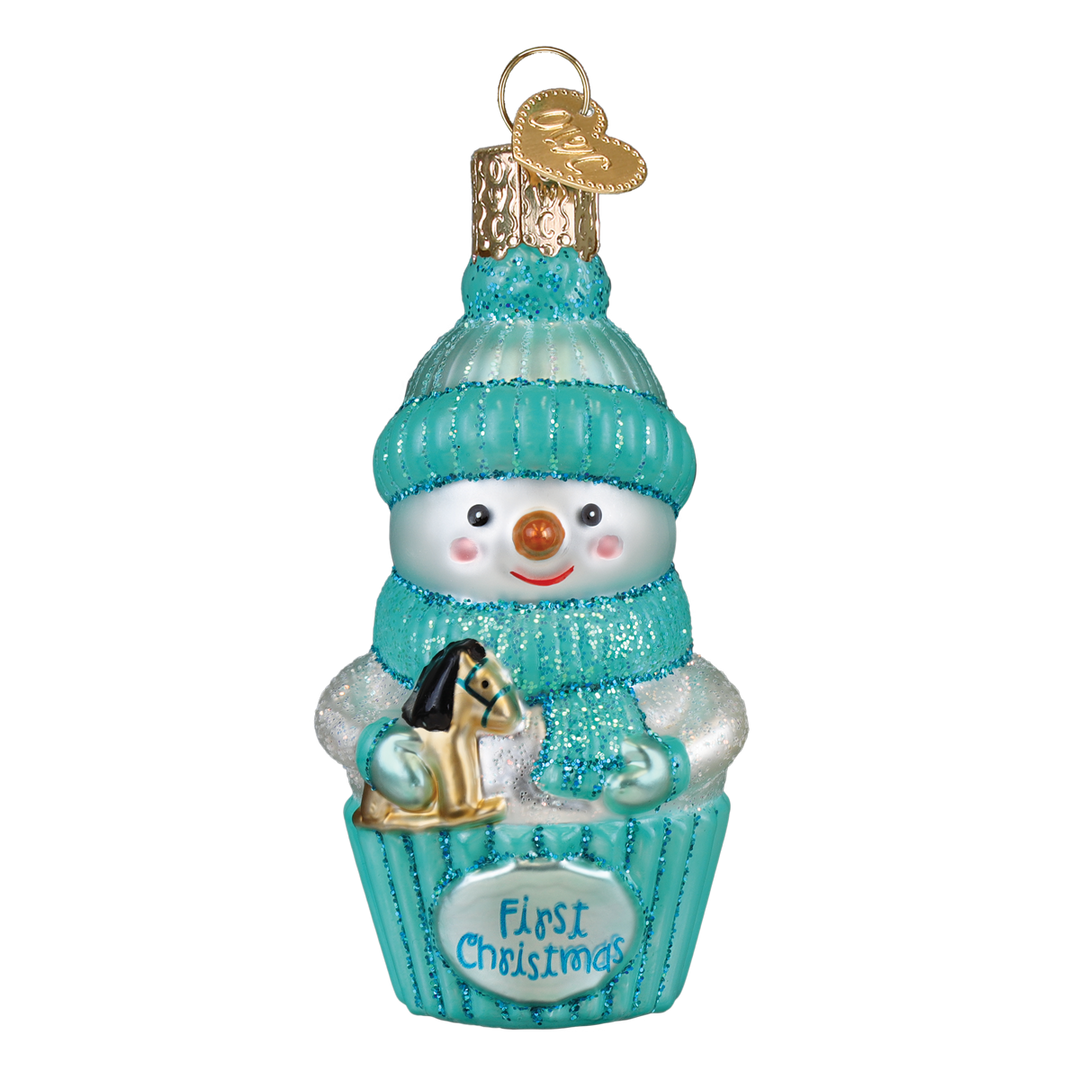 Aqua snow baby ornament in a knit hat holding a rocking horse in a First Christmas cupcake, on white