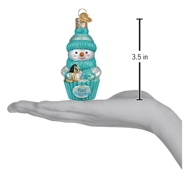 Aqua snow baby ornament on an open palm beside a 3.5 inch height marker
