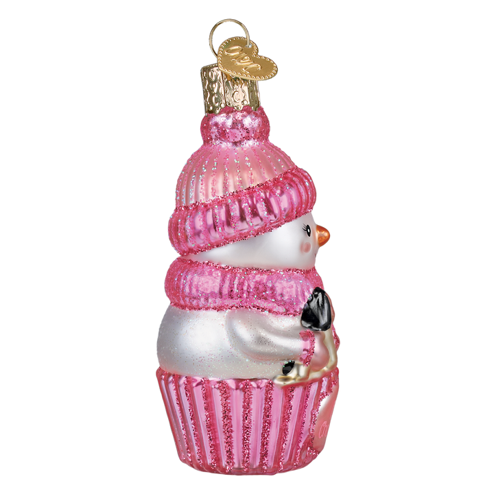 Side of the pink snow baby ornament with the rocking horse tucked in her arms