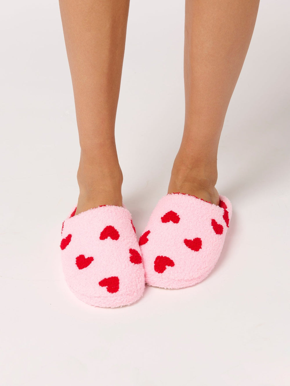 Front view of feet in pink heart slippers, a cozy Valentine's Day gift for her