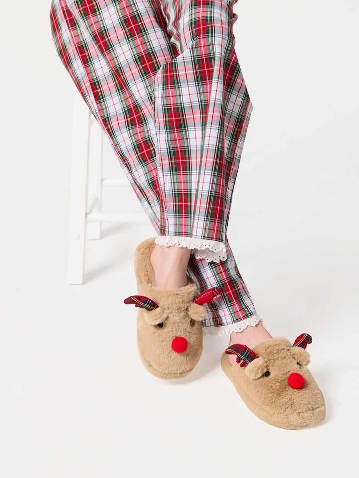Reindeer slippers worn with red plaid pajama pants
