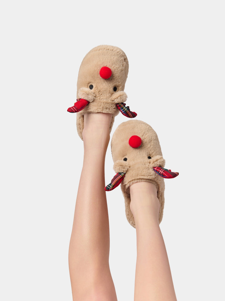 Legs raised wearing faux fur reindeer slippers with plaid antlers