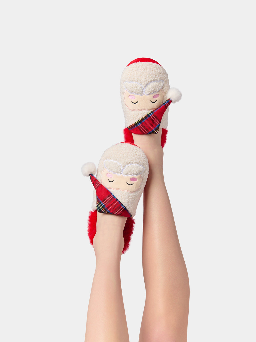 Legs raised wearing Santa slippers with plaid hats