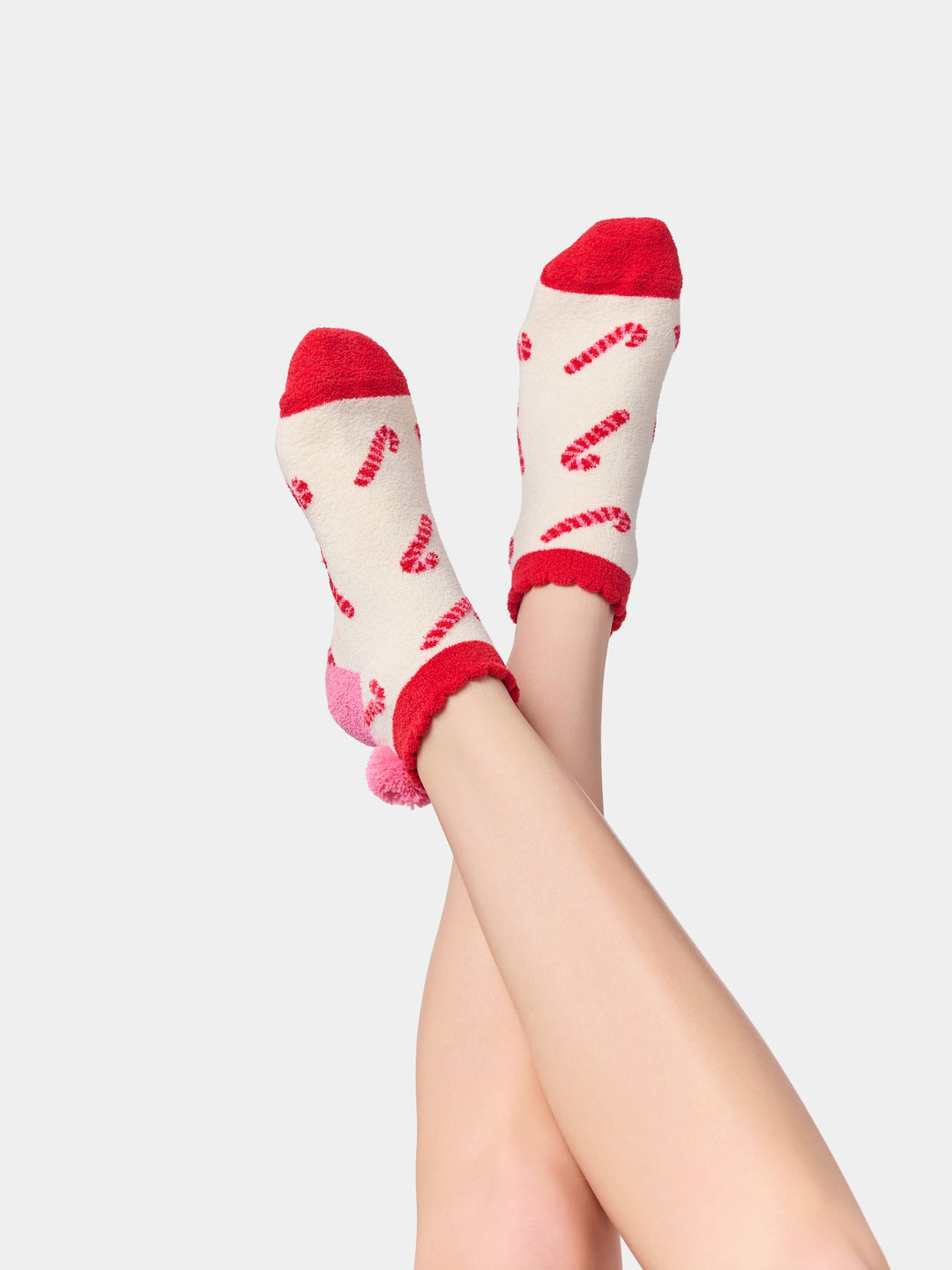 Legs raised wearing ivory candy cane socks