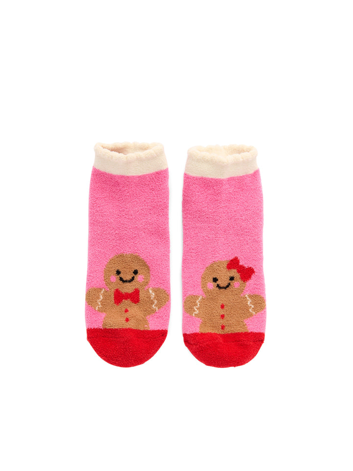 Pair of pink fuzzy socks with gingerbread cookie characters on white