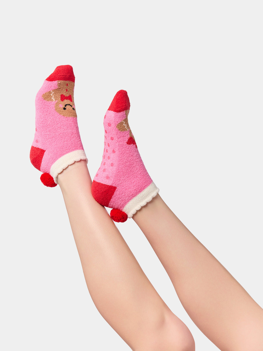 Side view of pink gingerbread socks with red heels