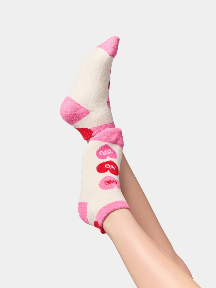 Side view of conversation heart socks with pink heels