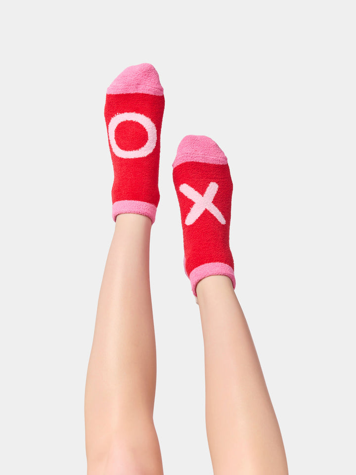 Legs raised wearing red XO socks