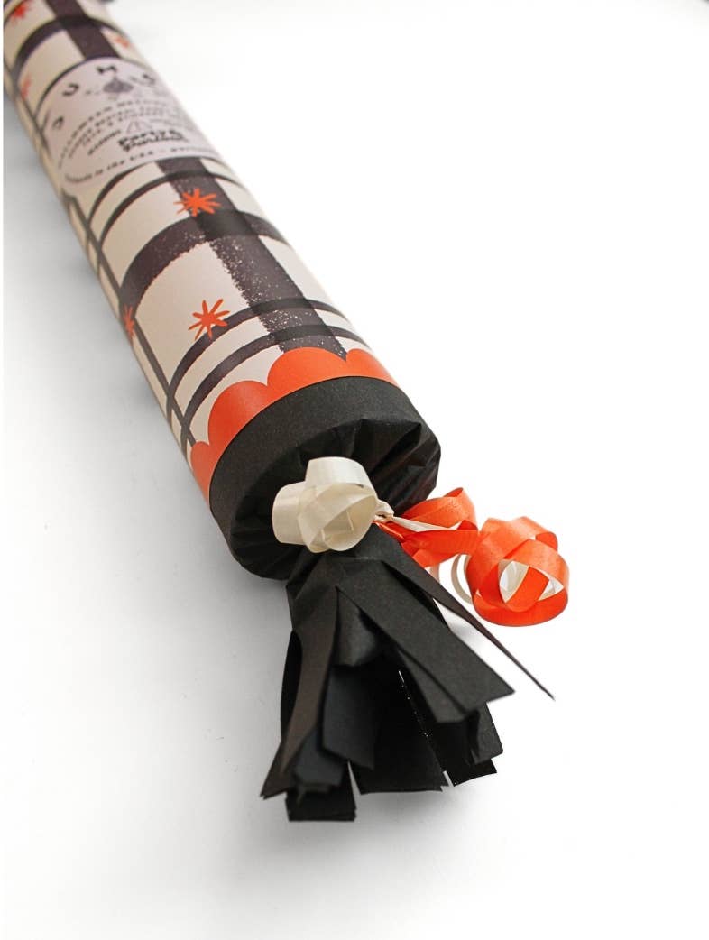 Close-up of the black plaid Halloween bon bon fringed end with orange and cream curling ribbon, ready for a boo basket
