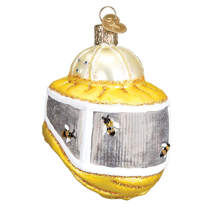 Beekeeper's hood ornament with a cream helmet, gray mesh veil, and yellow drape on a white background